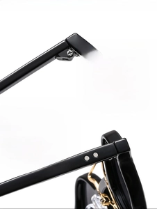 Detailed macro view of durable metal hinge and textured black frame of punk sunglasses