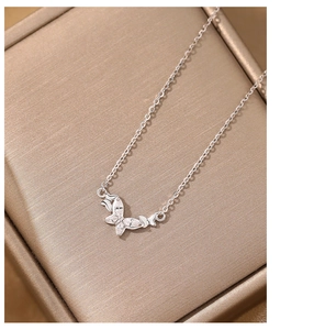 Detail of silver butterfly pendant necklace featuring white marquise zirconia stones
