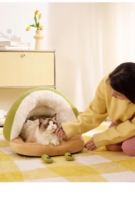 Close-up of avocado pet bed with green teddy fleece and soft plush lining for cats
