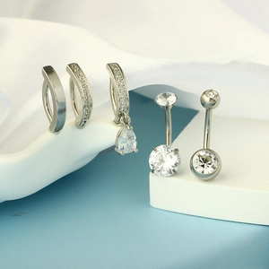 Macro shot of 5 stainless steel navel rings set with clear cubic zirconia crystals