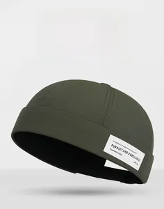 Detail of army green dock cap featuring side fabric patch and adjustable back strap