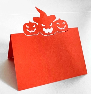 Detail of orange Halloween place card with laser-cut pumpkin and witch hat design