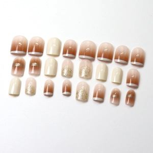French champagne gradient press-on nails with silver glitter and milky white accents