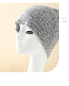 Detail of light grey cashmere knit beanie with premium braided texture on a model