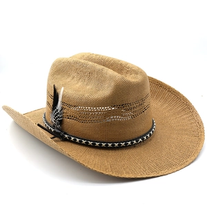 Detail of straw cowboy hat featuring woven band, feather accent and breathable holes