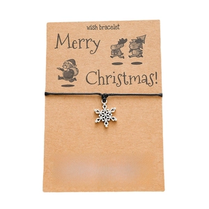 Detail of Christmas snowflake pendant wish bracelet on a Kraft paper display card