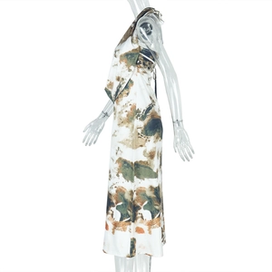 Side view of white maxi dress with green and orange abstract ink art prints on a model