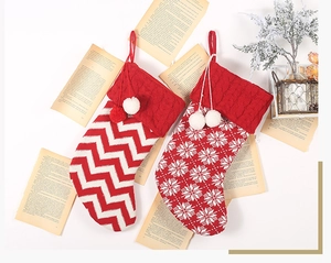 Detail of red and white knit Christmas stockings with snowflake and zigzag patterns