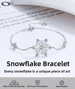 Detail of 925 sterling silver snowflake bracelet with blue zircon and elegant plated finish