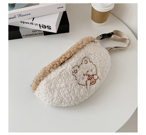 Detail shot of cute teddy bear embroidery on white fleece waist bag on a table