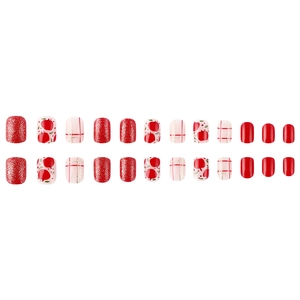 Short square Christmas press-on nails featuring red apple patterns and glitter accents
