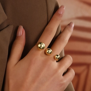 Close-up of 18k gold plated triple-bead layered open ring on finger detail