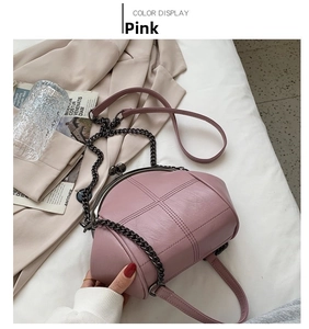 Top view of pink quilted shell bag with vintage metal clasp and chain strap