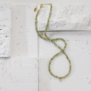 Olive green beaded necklace with sparkling zircon pendant and gold stainless steel clasp