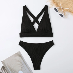 Detail of black ribbed fabric high waist bikini with cross back straps and summer accessories