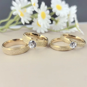 Close-up of titanium steel couple rings with micro-set zircon and frosted finish
