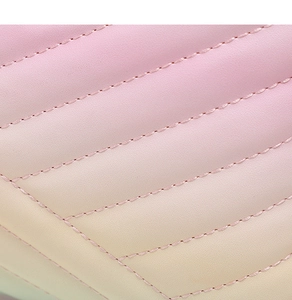 Close-up of pink gradient quilted leather texture with detailed diamond stitching pattern