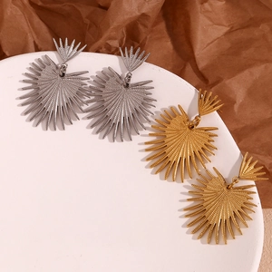 Detailed close-up of large radial fan-shaped drop earrings in gold and silver finish