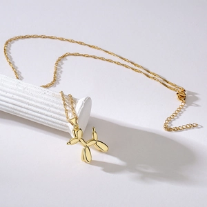 Minimalist 18K gold plated balloon dog pendant necklace on white display stand