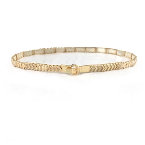 Minimalist gold metal elastic belt for women with arrow texture on white background