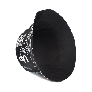 Detail of black bucket hat featuring white graffiti style letter prints and cotton fabric
