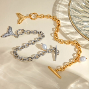 Detailed view of gold and silver whale tail bracelets with pearls and OT buckles