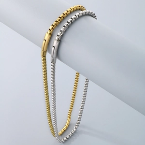 Close-up of gold and silver box chain necklaces with magnetic buckle in matte finish