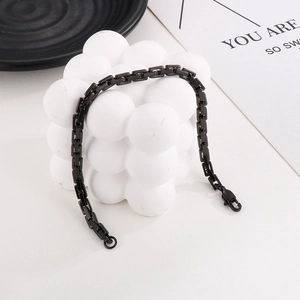 Close-up of black stainless steel square link chain necklace with lobster clasp closure