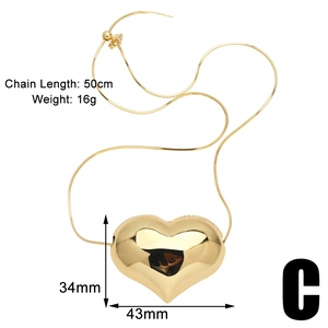 Detailed view of large gold heart pendant necklace with dimensions 34mm by 43mm