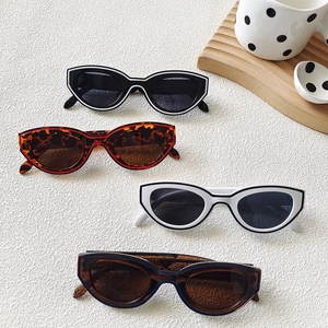 Retro Y2K cat-eye sunglasses collection with layered frames in four stylish colorways