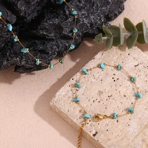 Detail of 18K gold-plated chain featuring turquoise stone fragments for women