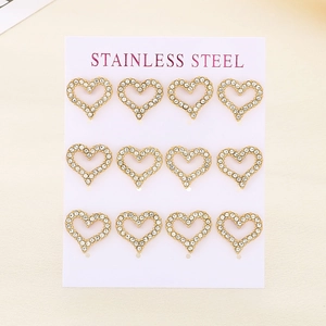 Macro detail of twelve gold heart-shaped stainless steel earrings with sparkling crystals