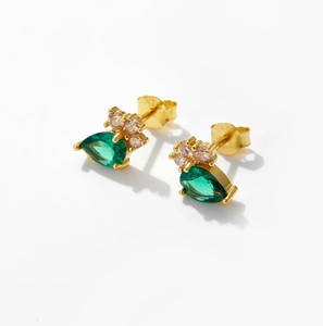 Detailed macro view of S925 sterling silver stamp on pear-cut green zircon earrings