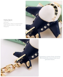 Detail of blue airplane keychain with sparkling crystals and gold-plated metal hardware