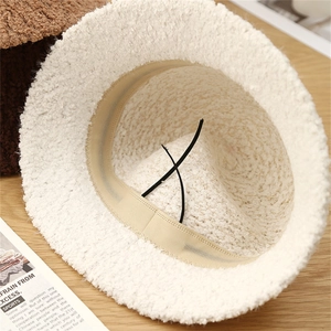 Internal view of white knit bucket hat showing the adjustable drawstring and sweatband