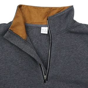 Macro detail of men's fleece hoodie collar with contrast lining and size M label
