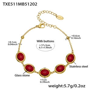 Detailed view of gold stainless steel bracelet with red oval faceted glass stones