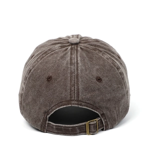 Detail of the adjustable metal buckle and vintage washed cotton fabric on the brown cap