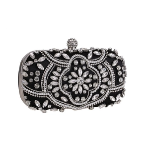 Detailed view of black satin evening clutch with white pearl and rhinestone floral patterns