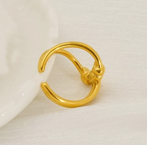 Close-up of a gold knotted irregular ring made of 18K plated titanium steel