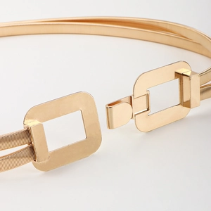 Close-up of golden double-strand elastic metal waist chain with rectangular buckle detail