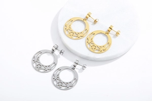 Detail of gold and silver moon star earrings on a white professional jewelry display stand