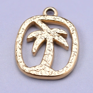 Macro detail of textured 18k gold plated coconut tree charm with hammered metal finish