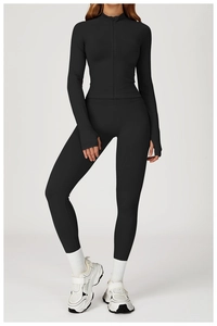 Detail of slim-fit yoga jacket showing stand collar, zipper, and functional thumb holes