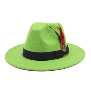 Detail of bright green fedora hat featuring black ribbon and colorful feather accent