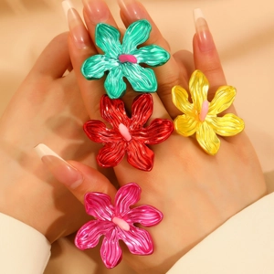 Set of oversized metal hollow flower rings in vibrant green, red, yellow and pink