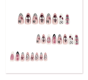 Detail of almond press-on nails featuring leopard print, gothic lips and metallic stars