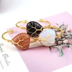 Handmade gold wire wrapped life tree bracelets with heart shaped natural crystal stones
