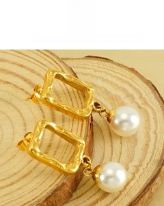 Detail of 18K vacuum plated golden square frame earring with a white round pearl drop