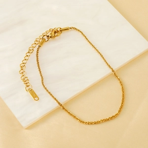 Elegant 18K gold plated stainless steel anklet with adjustable chain on marble background